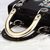 Black leather bedge embroid metal top handle bag