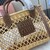 Woven fabric handbag with leather trim